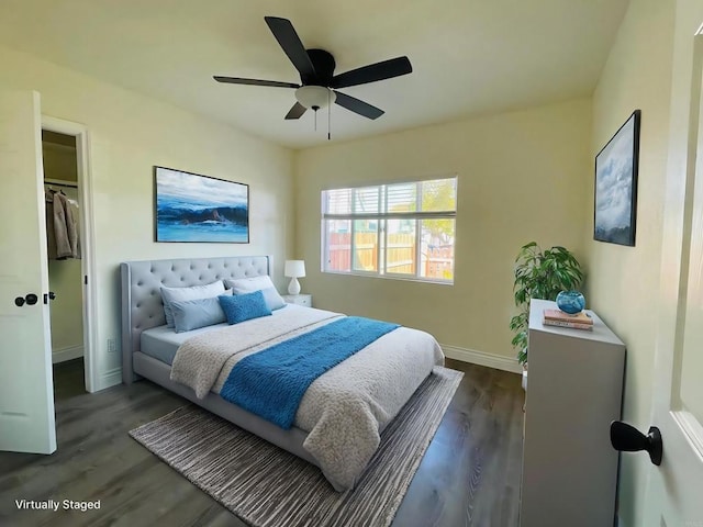 bedroom featuring a ceiling fan, baseboards, and wood finished floors