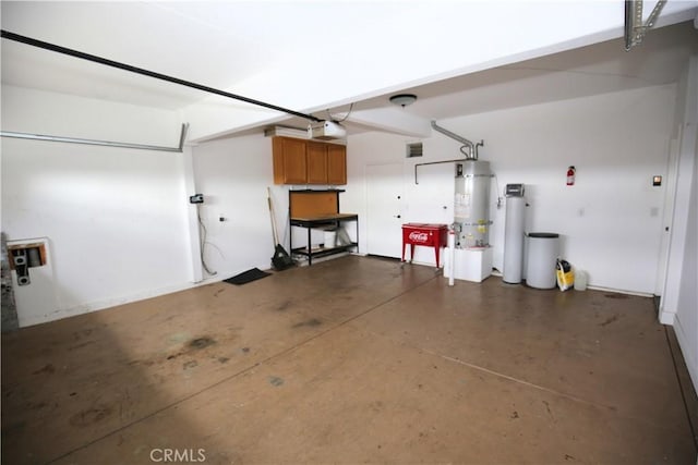 garage featuring a garage door opener and water heater