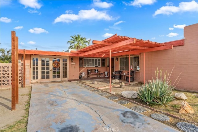 rear view of property featuring french doors and a patio