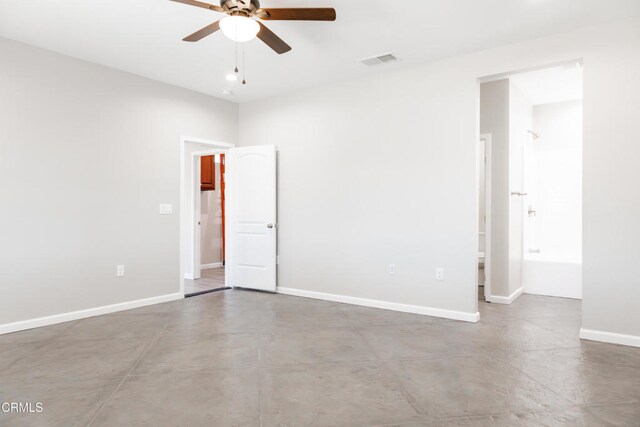 unfurnished room with visible vents, ceiling fan, concrete floors, and baseboards