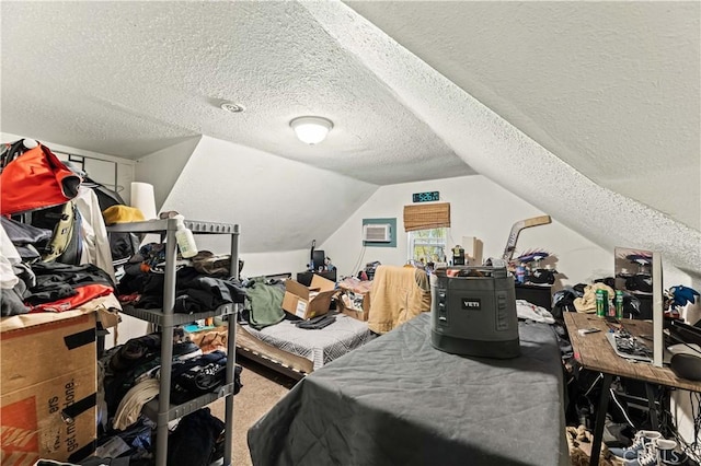 bedroom featuring carpet flooring, a textured ceiling, and lofted ceiling