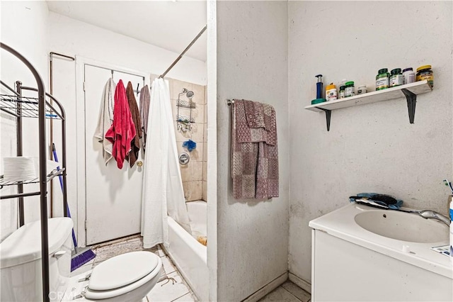 bathroom featuring toilet, shower / bath combo with shower curtain, and a sink