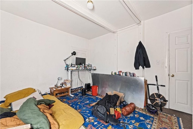 bedroom featuring beamed ceiling and carpet flooring