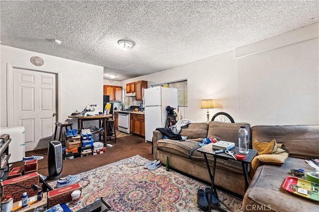 living area with a textured ceiling and dark colored carpet