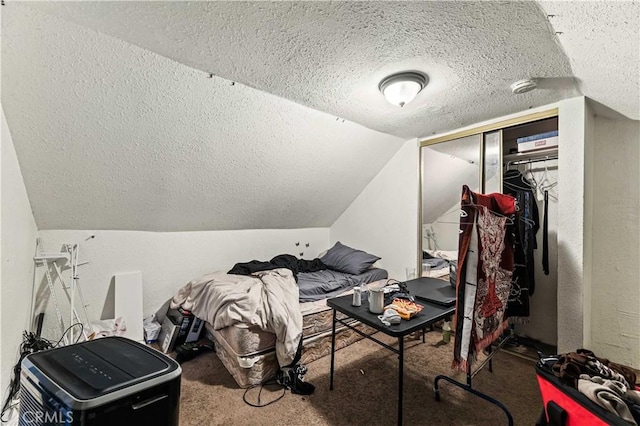 interior space featuring a closet, a textured ceiling, a textured wall, and vaulted ceiling