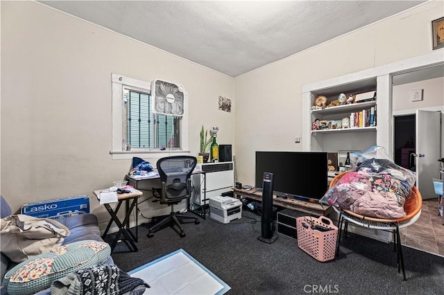 home office with a textured ceiling and carpet flooring