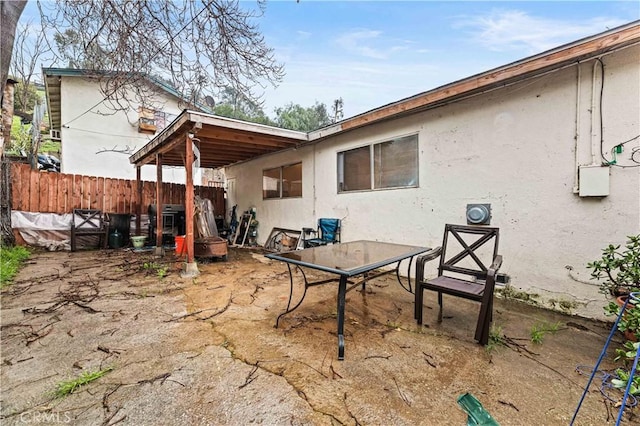 back of house featuring stucco siding, a patio, and fence