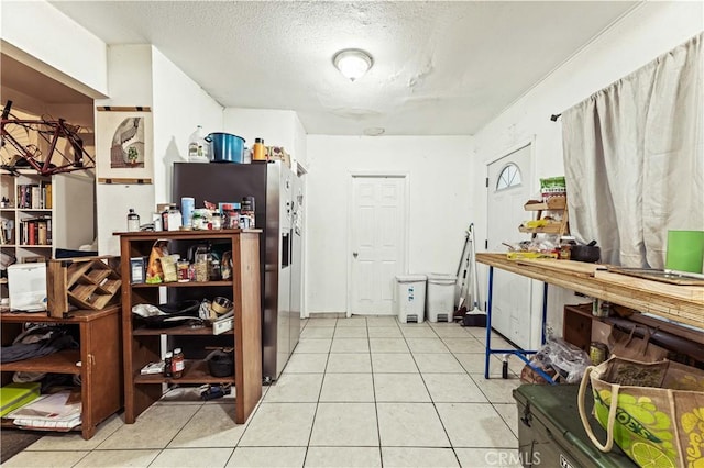 kitchen with light tile patterned floors and a textured ceiling