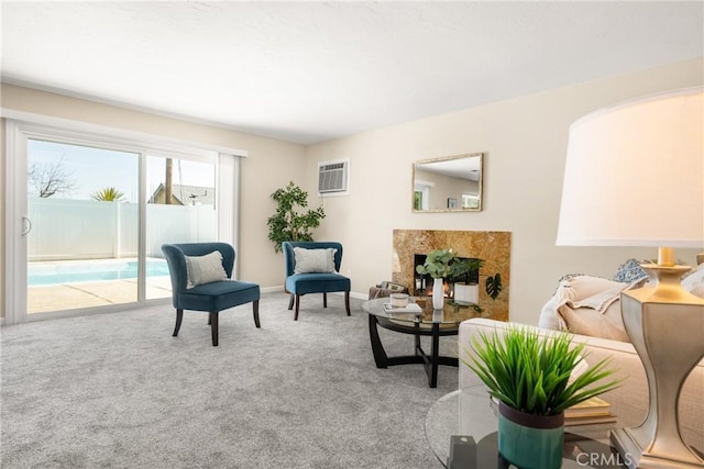 living area featuring a wall unit AC, carpet flooring, and baseboards