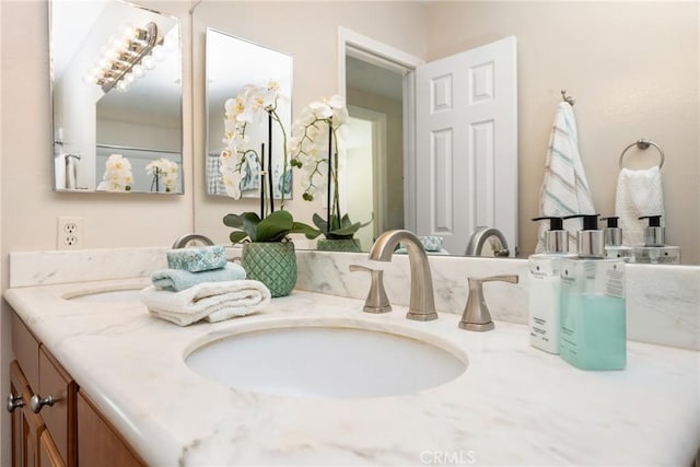 full bath with a sink and double vanity