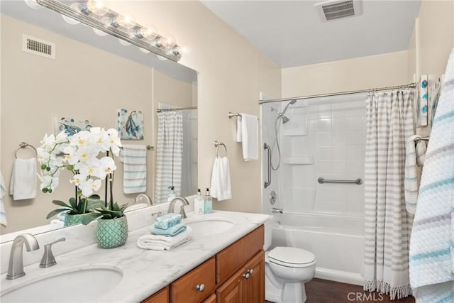 full bath featuring a sink, visible vents, and double vanity