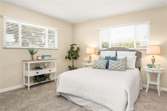 bedroom featuring baseboards and carpet