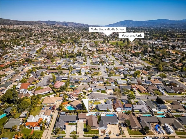 drone / aerial view featuring a residential view and a mountain view