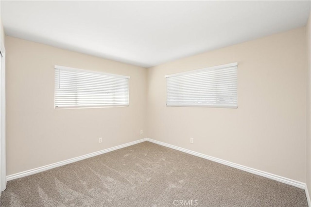 spare room with carpet flooring and baseboards