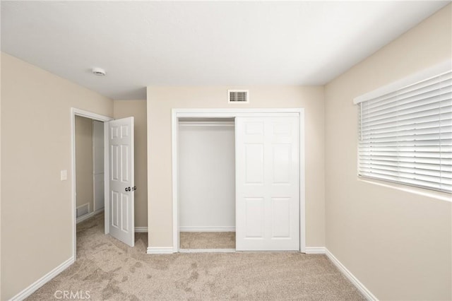 unfurnished bedroom featuring visible vents, baseboards, a closet, and carpet floors