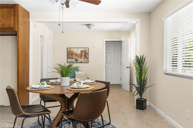 dining area featuring baseboards, light tile patterned flooring, and a ceiling fan