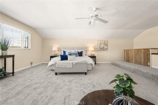 bedroom with a textured ceiling, baseboards, carpet, and vaulted ceiling