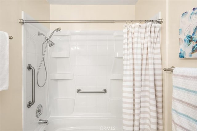 bathroom with shower / bath combination with curtain