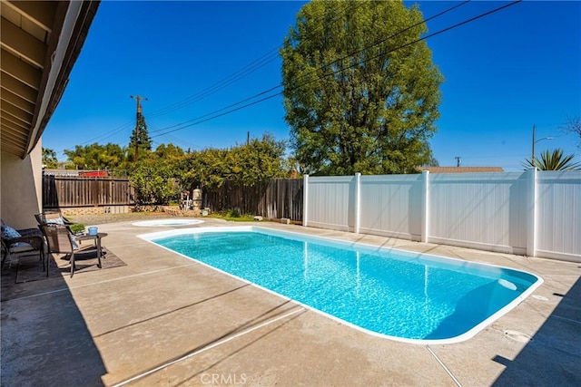 view of pool with a patio, a fenced backyard, and a fenced in pool