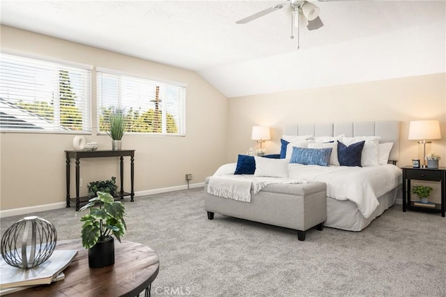 carpeted bedroom with ceiling fan, baseboards, and lofted ceiling