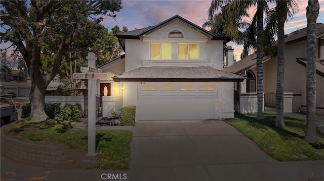 3266 Ashgate Ct, Ontario, CA 91761 - traditional home with driveway, roof with shingles, stucco siding, fence, and a garage