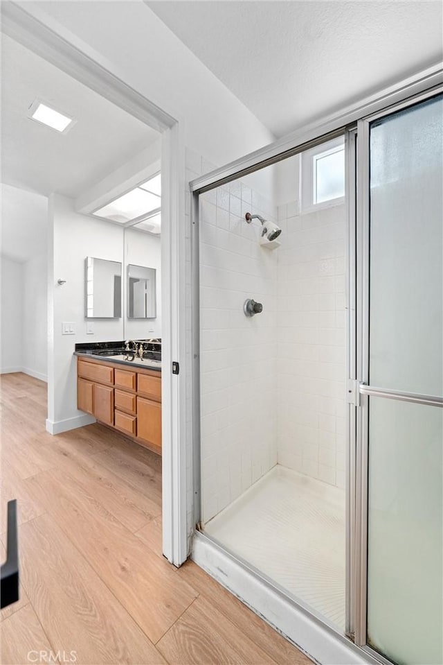 3266 Ashgate Ct, Ontario, CA 91761 - full bath with a shower stall, baseboards, wood finished floors, and vanity