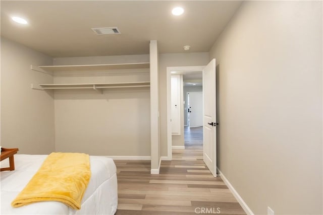 bedroom with light wood-type flooring, visible vents, baseboards, and recessed lighting