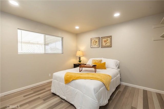 bedroom with recessed lighting, baseboards, and wood finished floors