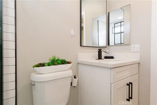 bathroom featuring toilet and vanity