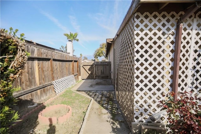 view of yard with a patio area, fence, and a gate