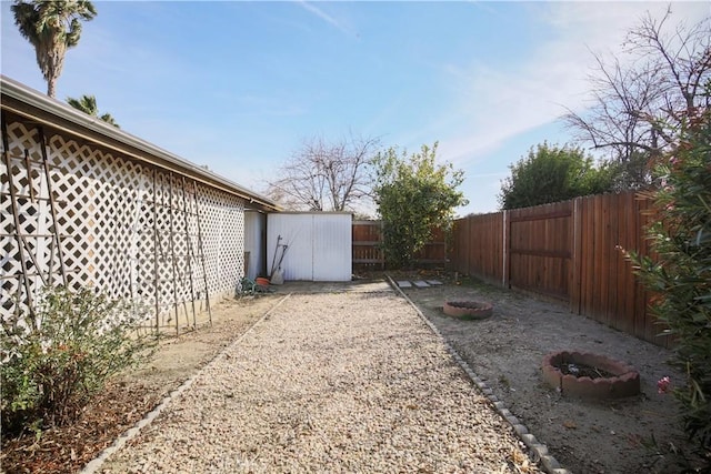 view of yard with an outdoor structure and a fenced backyard