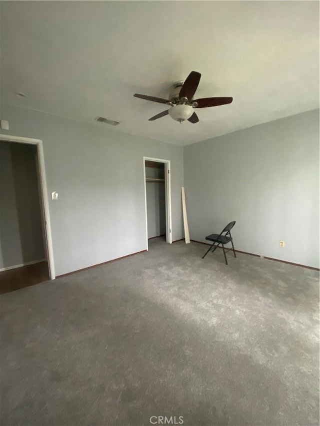 unfurnished bedroom featuring visible vents, carpet, a closet, and ceiling fan