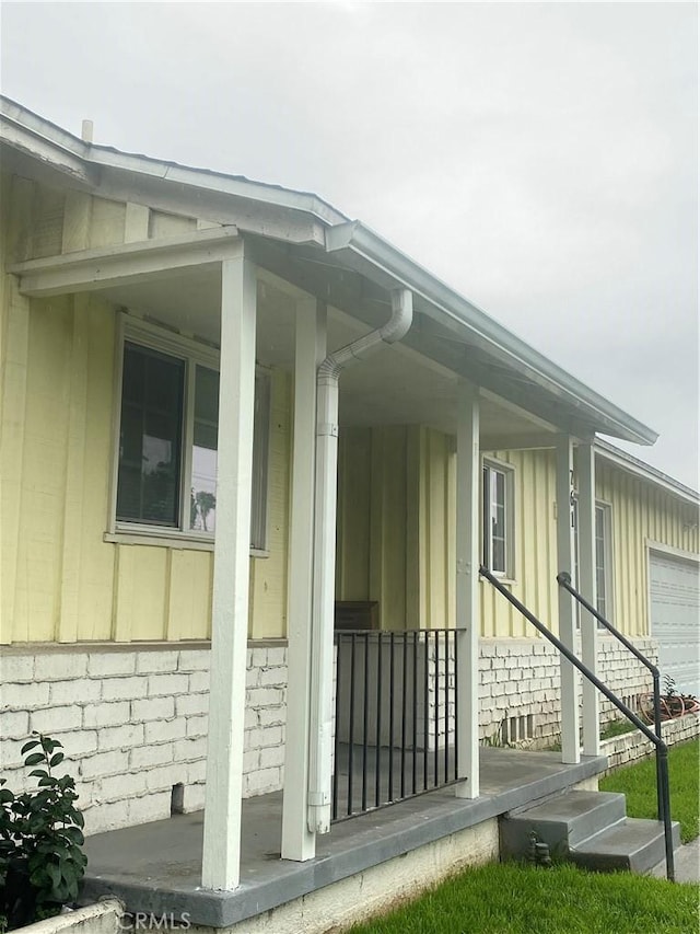 view of side of property with covered porch