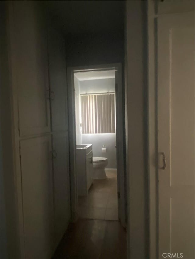 hallway with tile patterned floors