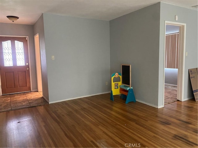 entrance foyer featuring visible vents, baseboards, and wood finished floors