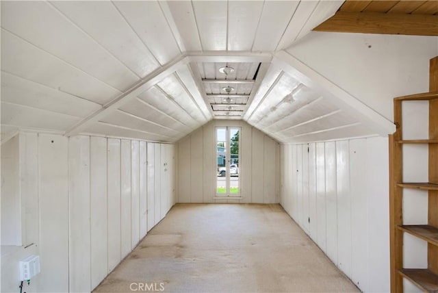 bonus room featuring lofted ceiling, light colored carpet, wood ceiling, and wood walls