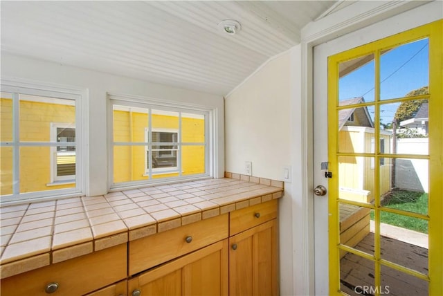 unfurnished sunroom featuring lofted ceiling