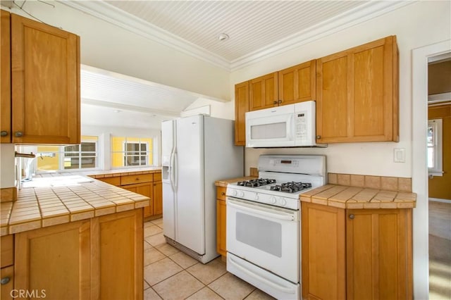 kitchen with white appliances, crown molding, light tile patterned flooring, and a healthy amount of sunlight