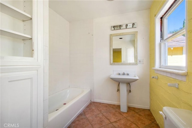 bathroom with tile patterned floors, a healthy amount of sunlight, toilet, and baseboards