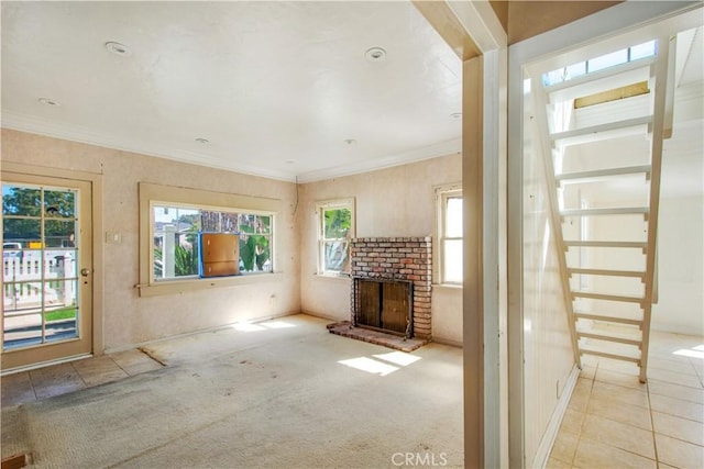 unfurnished living room with a wealth of natural light, a fireplace, and ornamental molding