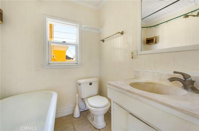 bathroom featuring toilet, ornamental molding, tile patterned flooring, a soaking tub, and vanity