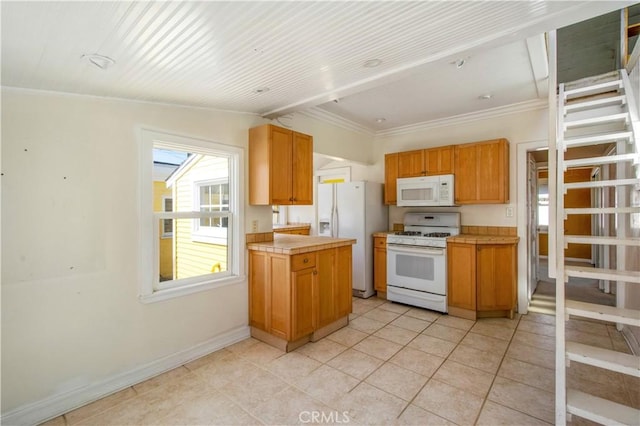 kitchen featuring white appliances, light tile patterned floors, baseboards, crown molding, and brown cabinets