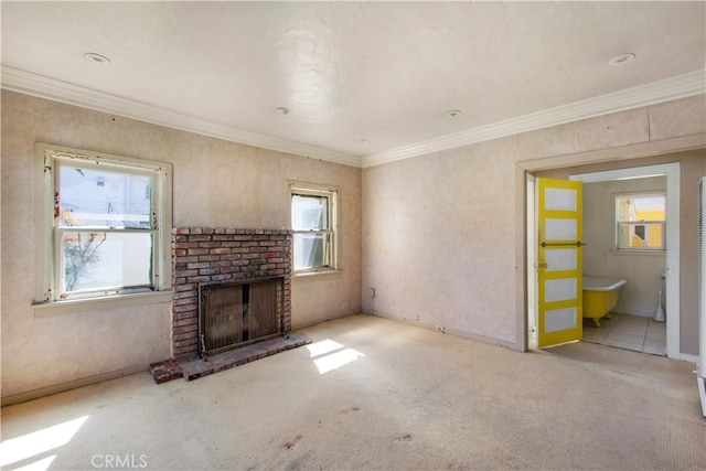 unfurnished living room featuring a fireplace, crown molding, and carpet