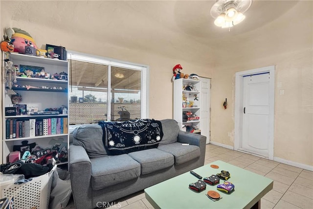 living room with light tile patterned floors and baseboards