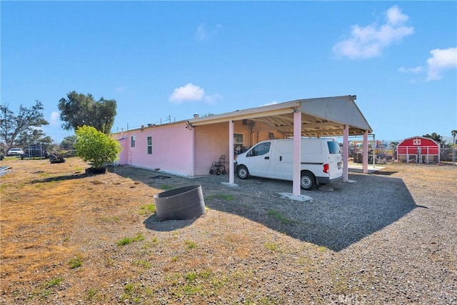 view of side of home featuring a carport and stucco siding