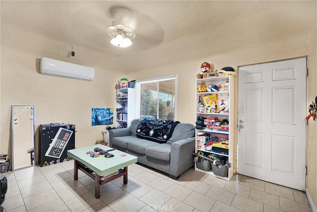 living room with a wall mounted air conditioner, a ceiling fan, and light tile patterned floors