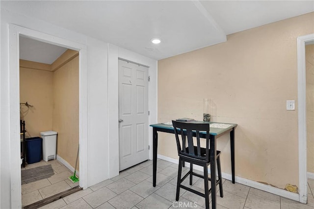 dining room featuring light tile patterned flooring and baseboards