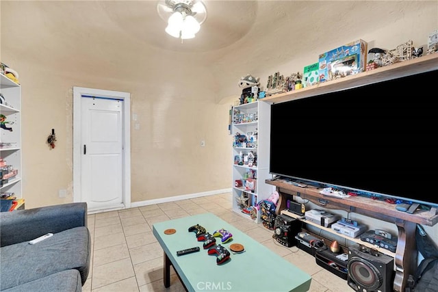 living room featuring baseboards, a ceiling fan, and tile patterned flooring