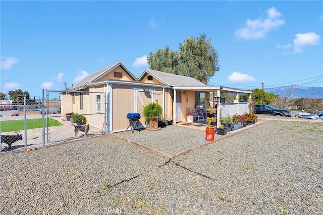 view of front of house featuring fence and a gate