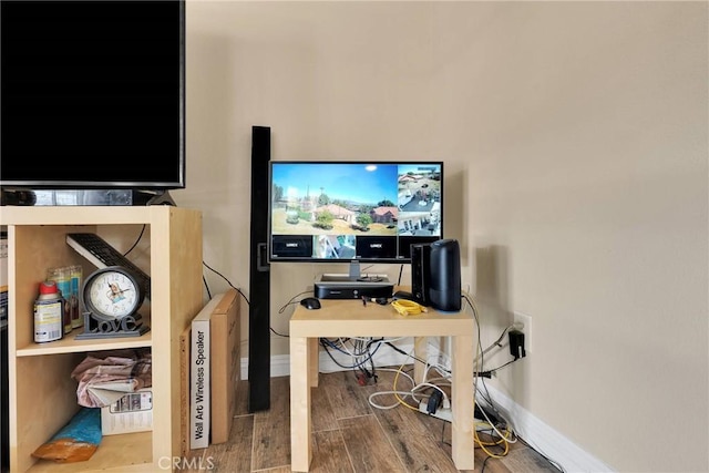 office space featuring baseboards and wood finished floors